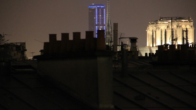 La Tour Maine-Montparnasse illuminée en bleu et Notre-Dame de Paris. Maine-Montparnasse Tower illuminated in blue and Notre-Dame de Paris.